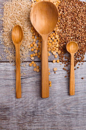 Three different wooden spoons are lying on the tableの写真素材