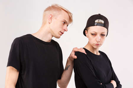 Couple in a quarrel. The guy asks forgiveness from the girl. Isolation.の写真素材