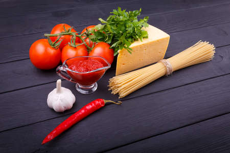 Various products for cooking spaghetti with cheese and tomatoes. Close-up. Indoors.の写真素材