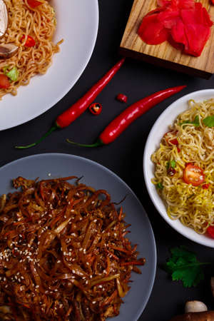On the table, various dishes of noodles. Indoors.の写真素材