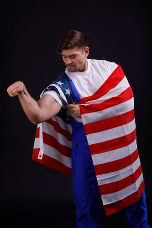 Worker showing a hand on a black backgroundの写真素材