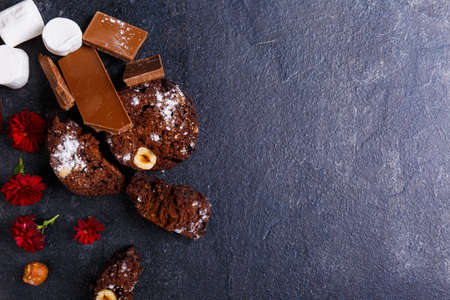 Chocolate cake with hazelnuts, marshmallows, chunks of powder sprinkled with powderの写真素材