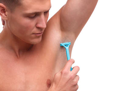 Guy shaves an armpit on a white isolated backgroundの写真素材