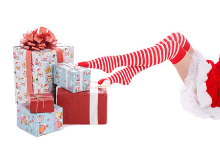Legs of a girl on gifts on a white isolated background