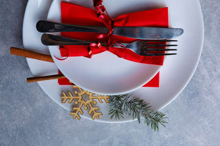 Plate in a plate with a knife and fork tied with a ribbon is shown not completely on a stone backgroundの写真素材