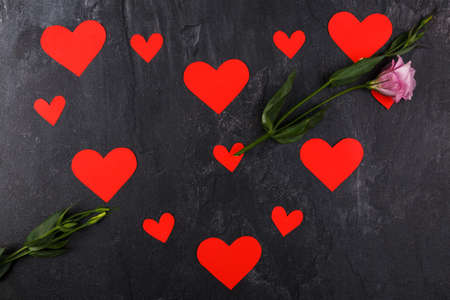 The hearts are lined up in one big heart lying horizontally. With Japanese roses in the form of an arrow passing through the heart on a stone backgroundの写真素材