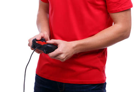 Hands of a guy in a red T-shirt and jeans are holding a joystick on a white isolated background....