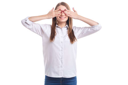 The girl closed her eyes with her hands on a white isolated backgroundの写真素材