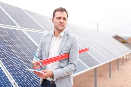 Head with a notebook and a horizontal marker on the background of solar panelsの写真素材