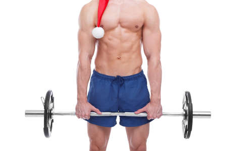 A muscular man stands with a barbell close-up on a white isolated backgroundの写真素材