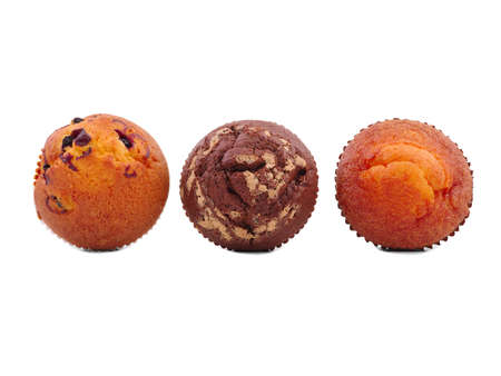 Three cupcakes with different fillings, isolated on a white background, top view, chocolate, with raisins, vanilla, in the middle lies a chocolate cupcake.の写真素材