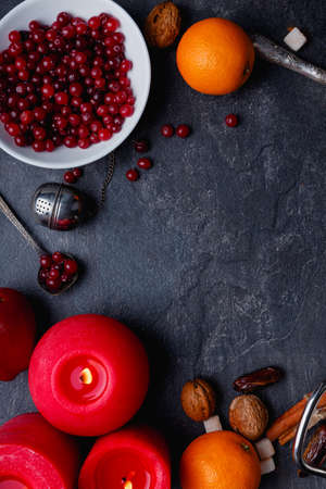 On a table a plate twith cranberry, oranges and burning candles. View from above. Indoors.の写真素材