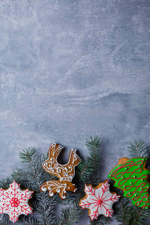 Background with a place for an inscription, with Christmas tree branches and sweet gingerbreads.の写真素材