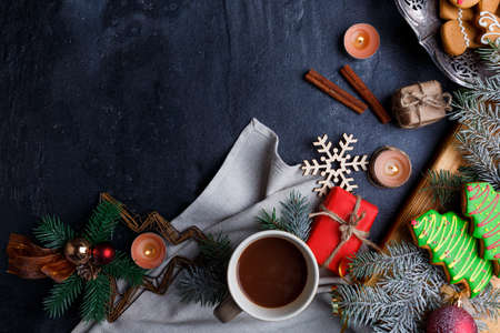 On a background with a place for inscription, the layout of a cup of tea, several cinnamon sticks and a sprig of trees.の写真素材