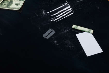 Are cocaine, a blade, a twisted dollar and a white card.