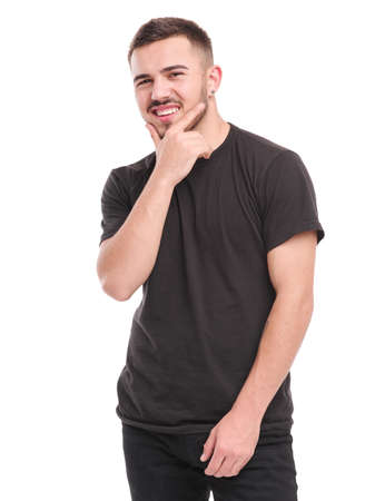 A guy with a smile holds his hand on his chin against a white isolated backgroundの写真素材