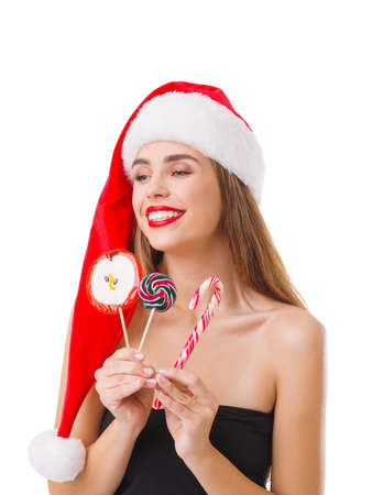 Girl holds different lollipops in hands on white isolated backgroundの写真素材