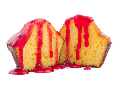 Two halves of a cupcake with red jam isolated on white backgroundの写真素材