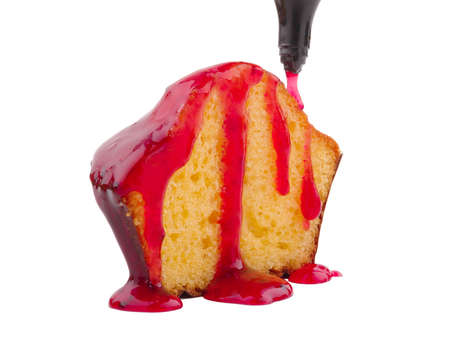 Half of vanilla, appetizing, freshly baked cupcake with red jam isolated on white backgroundの写真素材