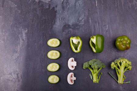 Vegetables on a black background. Macro photography. Top view of delicious vegetables. Beautiful concept of a healthy diet for your project. Top view, free space for text.の写真素材