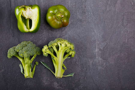Appetizing and juicy broccoli and green paprika below on a black background. Copy space. Free space for textの写真素材