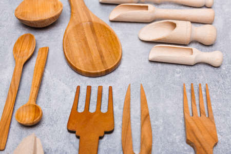 Set of wooden different spoons, forks, stingy appliances on a gray backgroundの写真素材