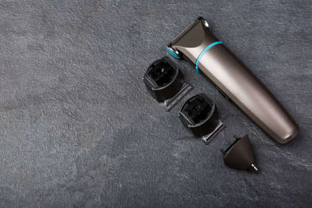 A trimmer with three different lays on a stone background. View from aboveの写真素材