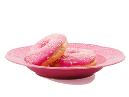 Two donuts in a plate on a white isolated backgroundの写真素材