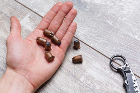 On the palm of the man, are cartridges.の写真素材