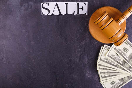 A hammer of the auctioneer with a stand, bills and a sign with the inscription of the sale.の写真素材