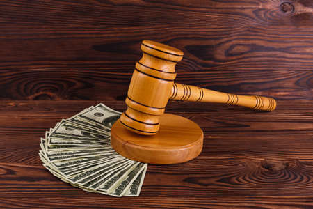 A lot of dollar bills and a wooden hammer. Details of the auction.の写真素材