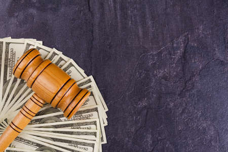 Dollar bills and a wooden hammer auctioneer. View from above.の写真素材