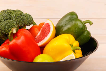 A plate with healthy and juicy citrus fruits and vegetables. Grapefruit, lime, broccoli and pepper.の写真素材