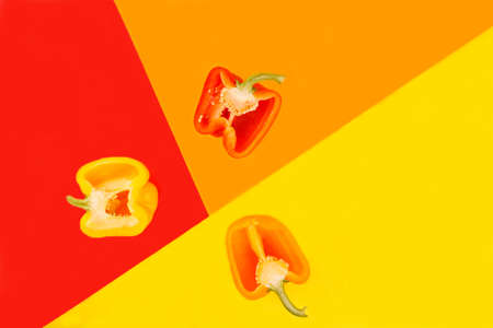 Halves of sweet peppers, yellow, red and orange color.の写真素材