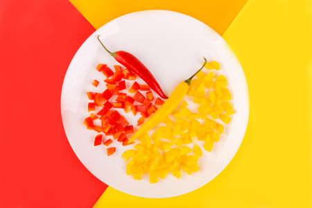 On a plate are two whole and chopped chili peppers. Inside.の写真素材