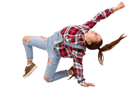 Young girl dancing sport dancing, in plaid shirt, isolated on white backgroundの写真素材