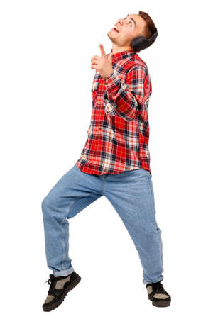 Young man dancing in checkered shirt and headphones, isolated on white backgroundの写真素材