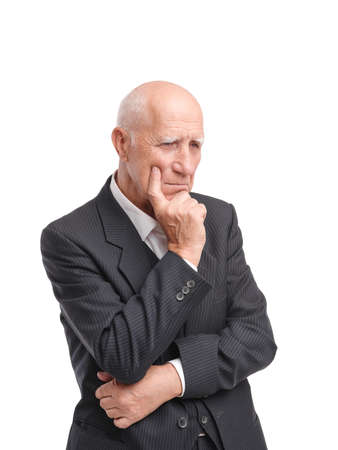 Grandfather stands thoughtfully close-up on white isolated backgroundの写真素材