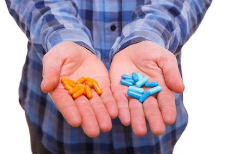 Sick guy holding capsules on palms against white isolated background