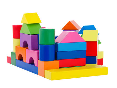 A pile of colored geometric shapes superimposed on each other, a child built a large building, the development of the hand's motor skills, isolated on a white backgroundの写真素材