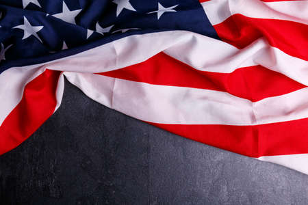 The American flag lies at the top on a gray backgroundの写真素材