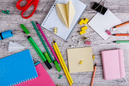 Various stationery, notebooks and clips, on a wooden background. Top view.の写真素材