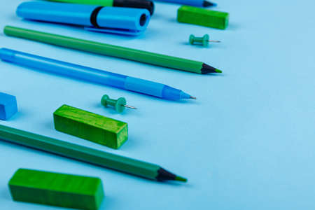 Pens, pencils, markers and other stationery, layout on a blue background.の写真素材