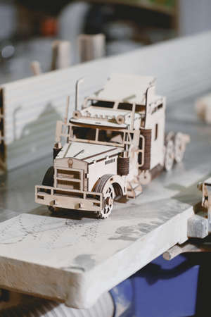 A little wooden toy car with small details. Close-up.