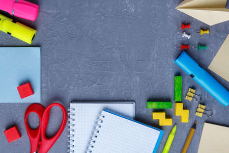 Arrangement from various stationery, notebooks and crayons on a dark background with a place for an inscription.の写真素材