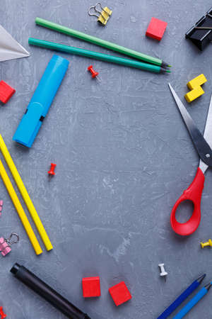 Layout of various colored pencils, clips for papers, markers and chalks on the background with a place for the inscription. View from above.の写真素材