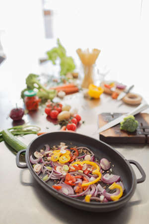 The process of cooking vegetables in a kitchen room. Close-up of different ingredients for a healthy dish.の写真素材