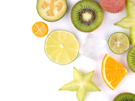 Top view of a ripe and tropical slices of fruits with cubes of ice isolated on a white background.の写真素材
