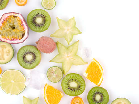 Top view of ripe and tropical slices of fruits with cubes of ice isolated on a white background.の写真素材
