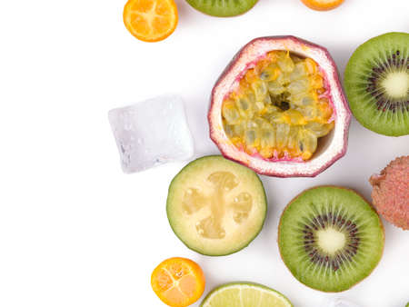 Top view of a ripe and tropical slices of fruits with cubes of ice isolated on a white background.の写真素材